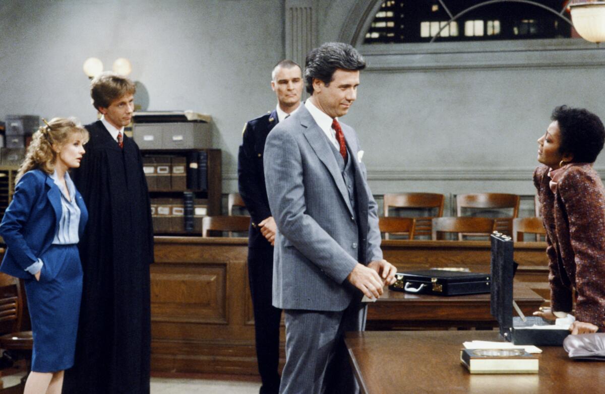 A group of people standing in a courtroom at night