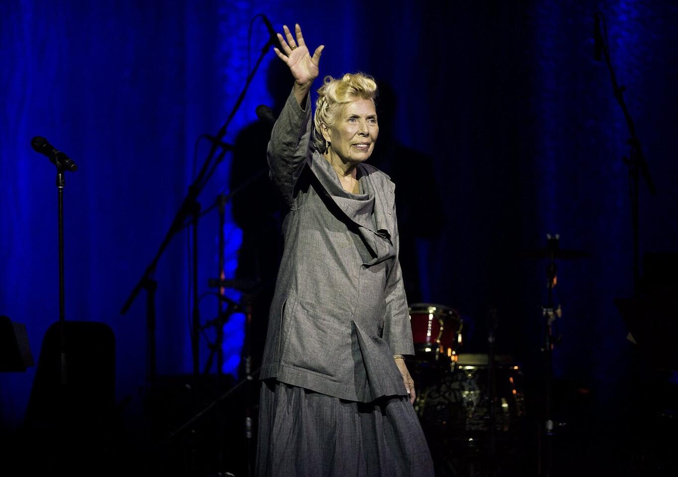 Joni Mitchell waves to the crowd during her 70th birthday tribute concert as part of the Luminato Festival at Massey Hall in Toronto.