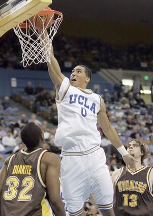 UCLA freshman forward Drew Gordon dunks over Wyoming's Mahamoud Diakite and Mikhail Linskens in the second half Tuesday night. Gordon had 14 points and 11 rebounds for the Bruins.
