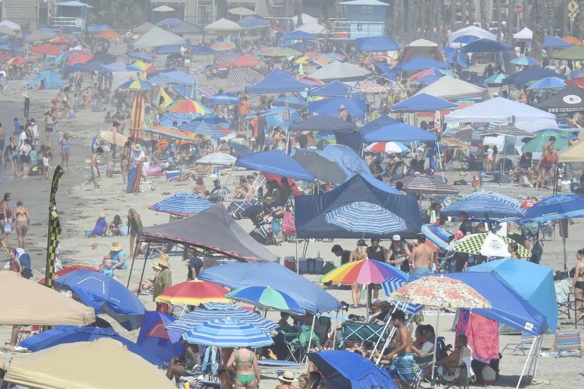 A heat wave drove enormous numbers of people to the beach in Oceanside.