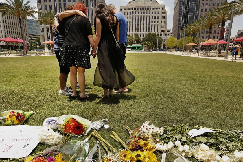 Friends of Shane Tomlinson, who was killed in the Pulse nightclub shooting, gather in prayer and remembrances in downtown Orlando on Monday.