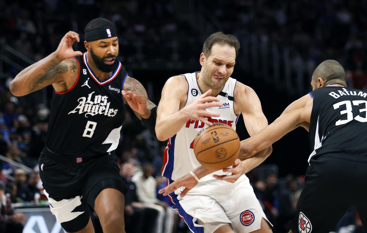Detroit's Bojan Bogdanovic has the ball knocked away by Clippers' Nicolas Batum after driving past forward Marcus Morris Sr.
