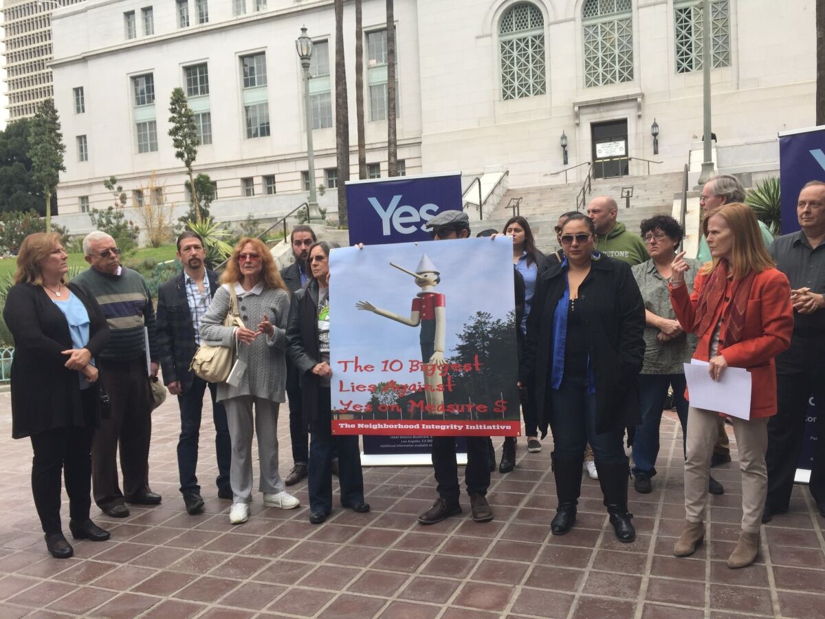 Backers of Measure S speak at a news conference Wednesday outside of Los Angeles City Hall.