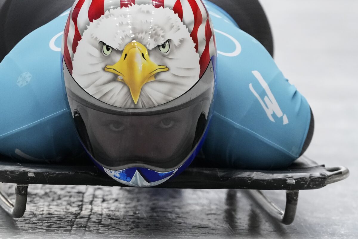 Katie Uhlaender of the United States speeds down the track during the women's skeleton training run at the 2022 Winter Olympics, Tuesday, Feb. 8, 2022, in the Yanqing district of Beijing. (AP Photo/Pavel Golovkin)