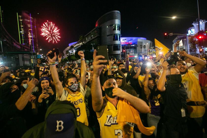 LOS ANGELES, CA - OCTOBER 11: Los Angeles Lakers fans gather near the Staples Center to celebrate the Lakers 106 - 93 game 6 over the Miami Heat on Sunday, Oct. 11, 2020 in Los Angeles, CA. (Jason Armond / Los Angeles Times)