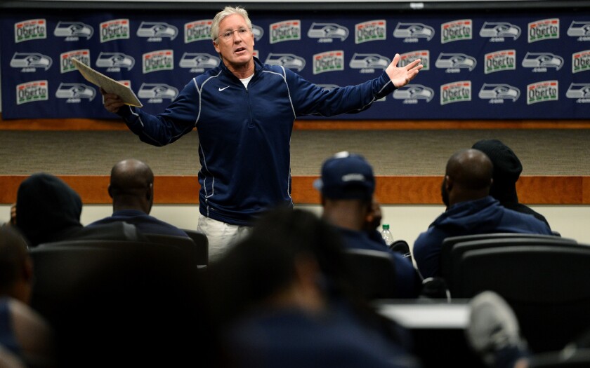 Seahawks head coach Pete Carroll rallies his players in the early morning during a team meeting at the practice facility in Seattle.