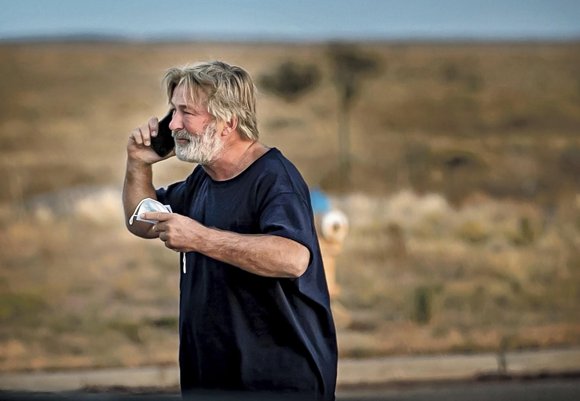 Alec Baldwin speaks on the phone outside the Santa Fe County Sheriff's Office in Santa Fe, N.M.
