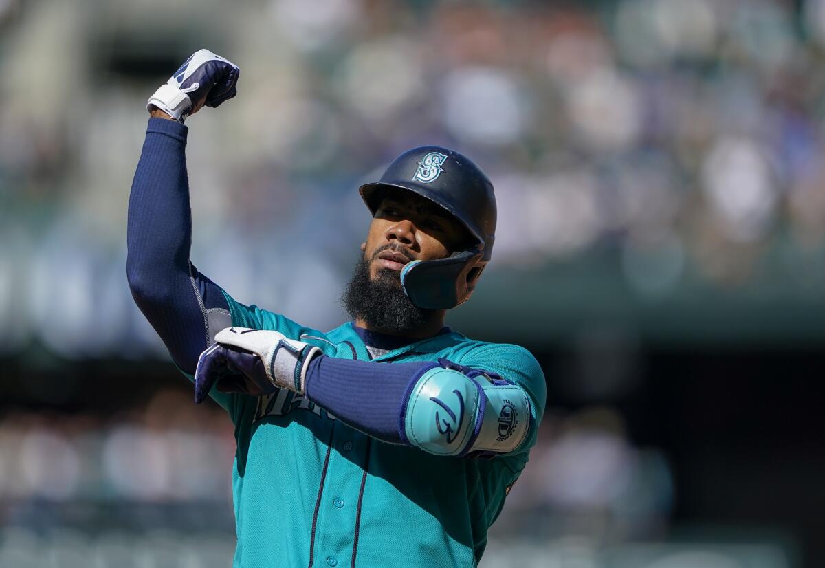 Seattle Mariners' Teoscar Hernandez gestures after an RBI single against the Angels on Sept. 13, 2023, in Seattle.