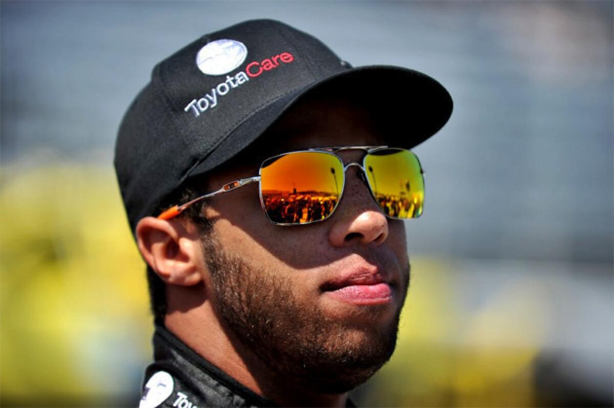 Darrell Wallace Jr. stands on the grid during pre-race ceremonies for the Kroger 250 at Martinsville Speedway.