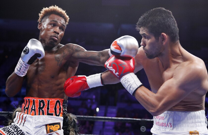 FILE - Jermell Charlo, left, fights Jorge Cota, of Mexico,