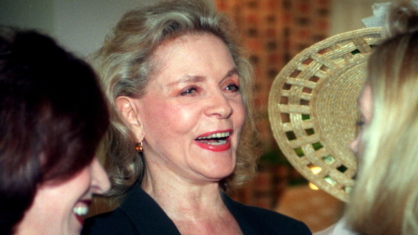 Bacall is surrounded by admirers in her Hyatt Regency Hotel suite on March 26, 1997. Later she was the honored guest at a benefit luncheon for the Pacific Symphony.