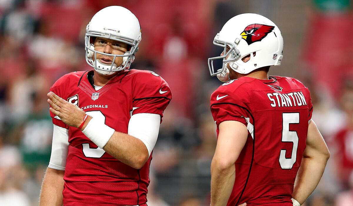 Cardinals quarterbacks Carson Palmer chats with Drew Stanton as they warm up for a game against the Philadelphia Eagles last month.