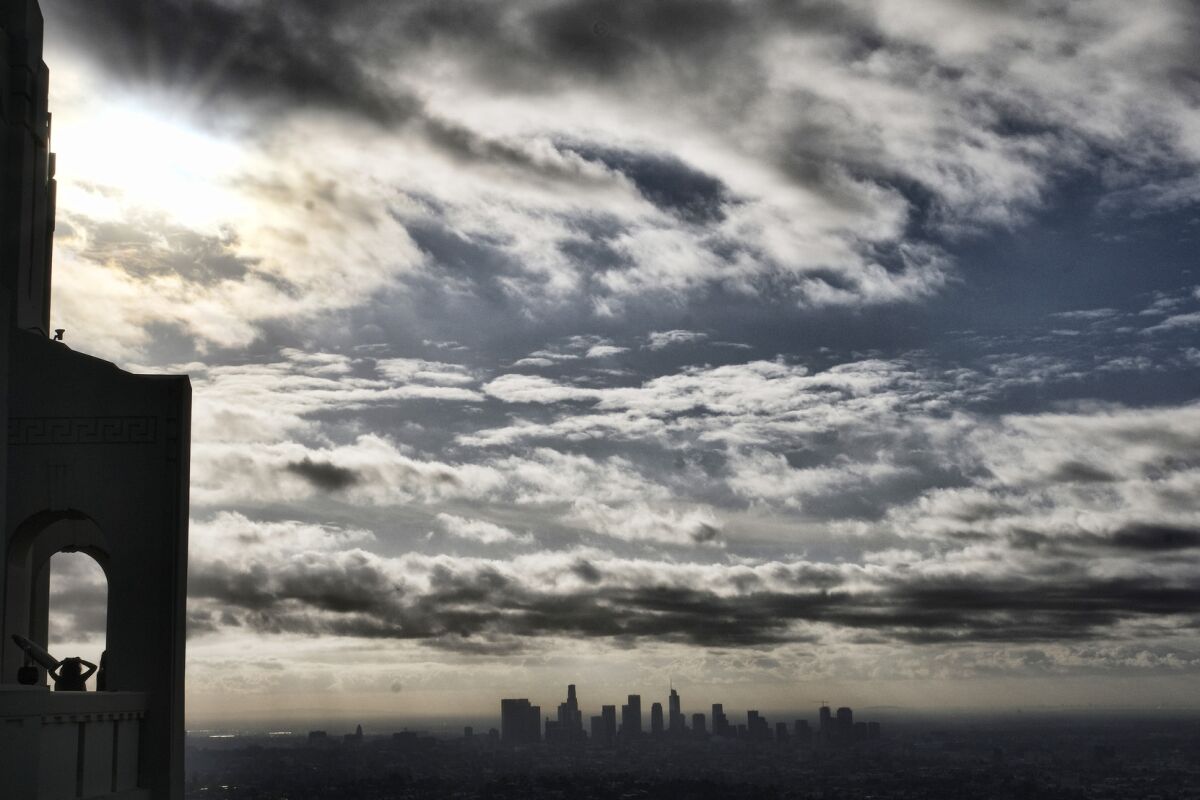 A photo taken from Griffith Observatory shows storm clouds moving over downtown Los Angeles.