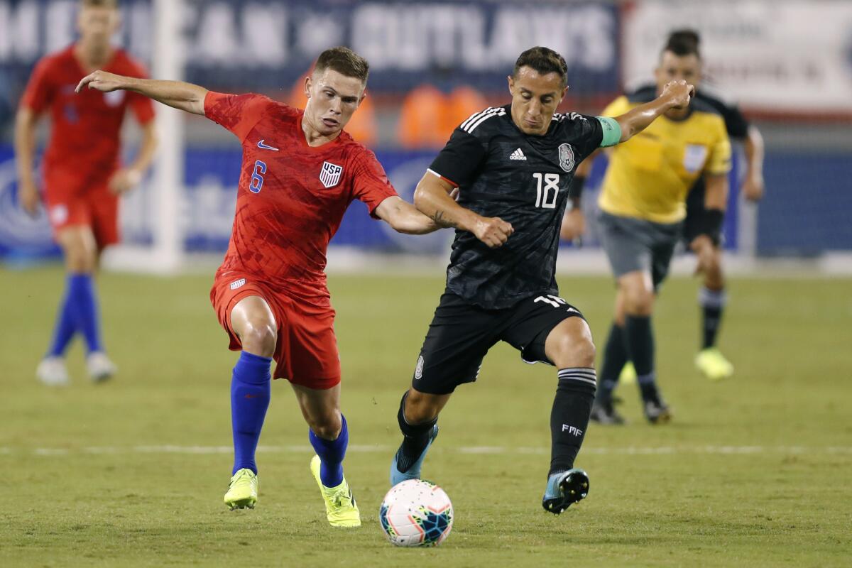 United States midfielder Wil Trapp (6) competes againt Mexico midfielder Andres Guardado (18) in the first half Friday.