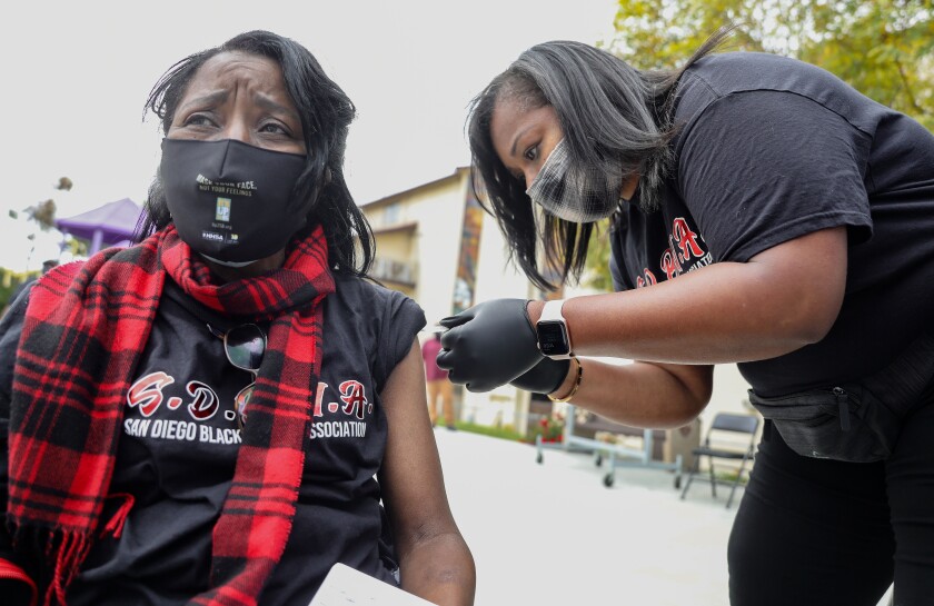Samantha Gambles-Farr, of the San Diego Black Nurses Association, gives Shirley Beck a vaccine at Bayview Baptist Church