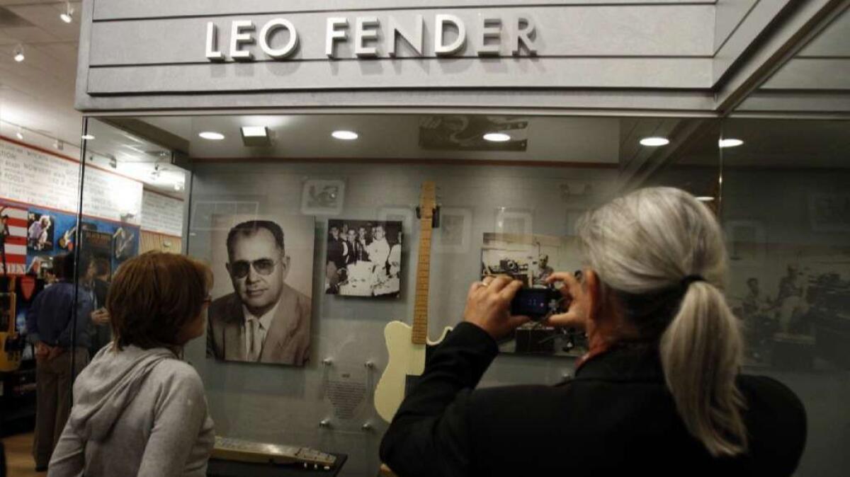 Guests view a display about Leo Fender at a Fender visitor center in Corona in 2011. Fender's second wife, Phyllis, is releasing a book about her late husband later this year.