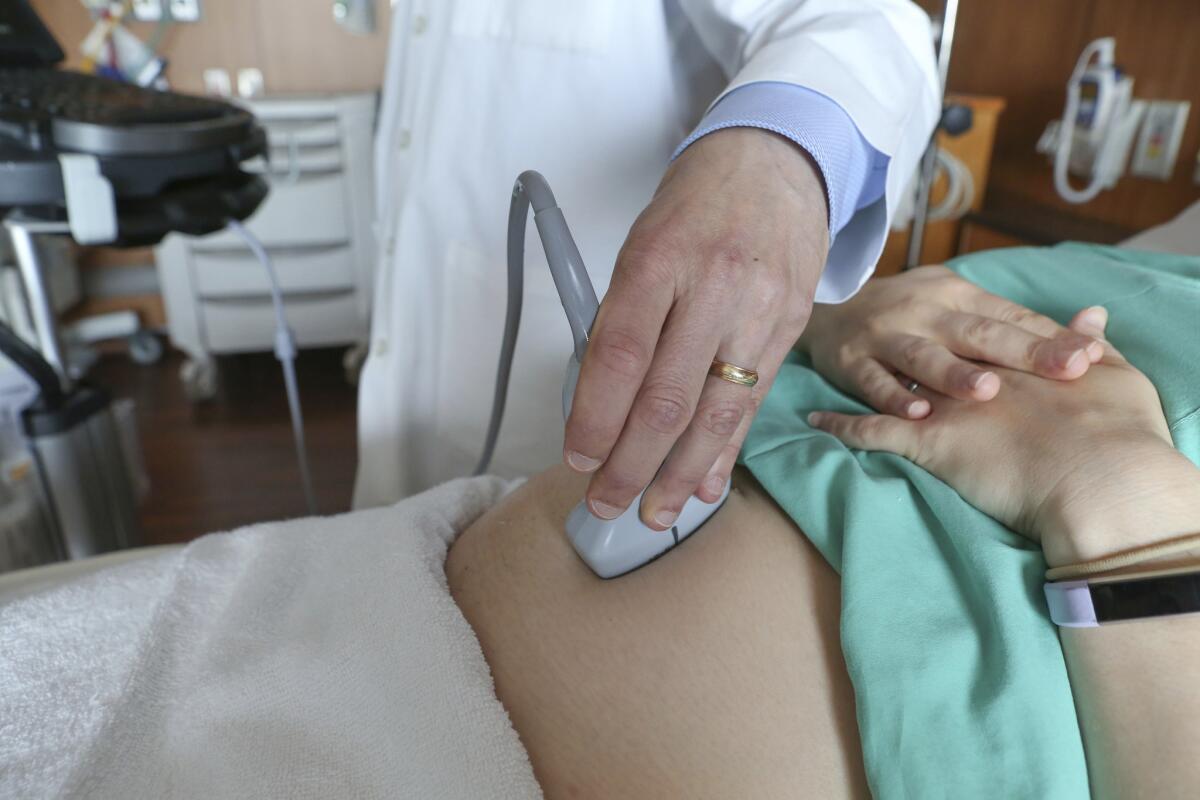 A doctor performs an ultrasound on a pregnant woman at a Chicago hospital in 2018.