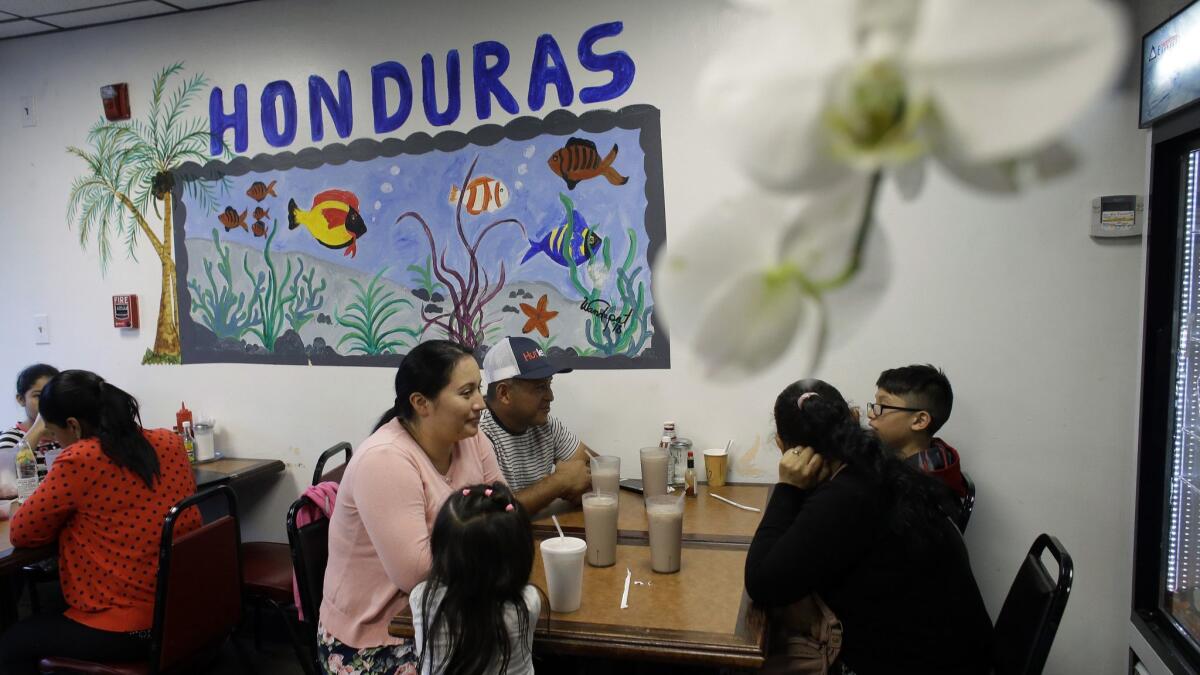 Diners eat in a Honduran-style restaurant last month in Chelsea, Mass.