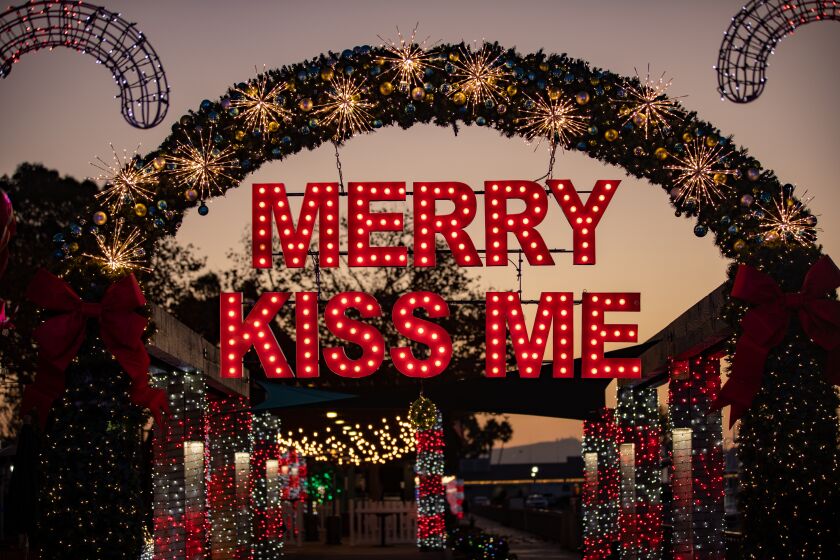 The popular “Merry Kiss Me” arch is part of the the annual holiday light display hosted by Dana Point Harbor Partners.
