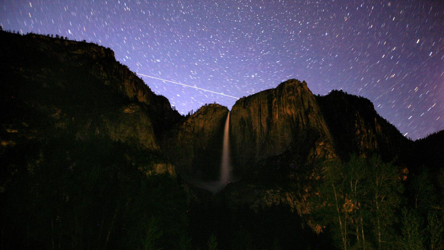 The stars in the skies over the Yosemite Valley illuminate the features of the park during a 17-minute exposure.