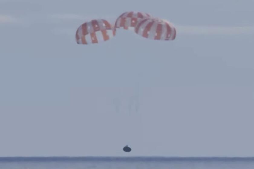 This photo provided by NASA shows the Orion capsule coming back from the moon. The capsule made a blisteringly fast return Sunday, Dec. 11, 2022, parachuting into the Pacific off Mexico to conclude a dramatic 25-day test flight. The mission should clear the way for astronauts on the program’s next lunar flyby, set for 2024. (NASA via AP)
