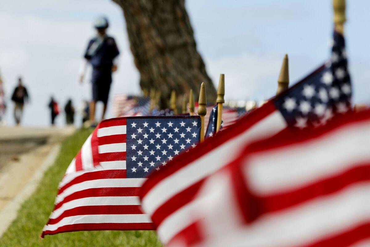 American flags are placed at headstones at Fort Rosecrans National Cemetery in honor of Memorial Day. 