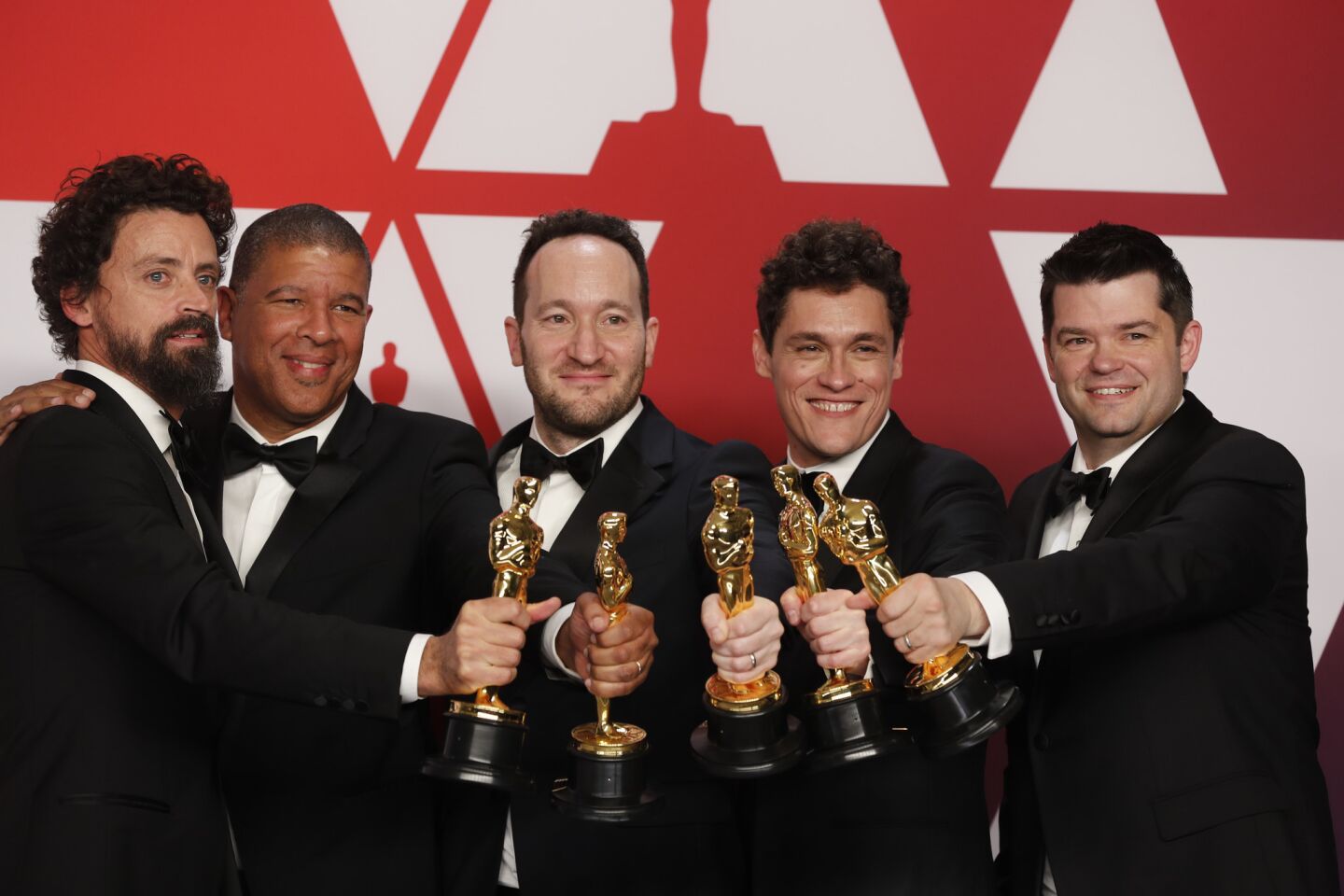 Bob Persichetti, left, Peter Ramsey, Rodney Rothman, Phil Lord and Christopher Miller, winners of the animated feature film award for "Spider-Man: Into the Spider-Verse."