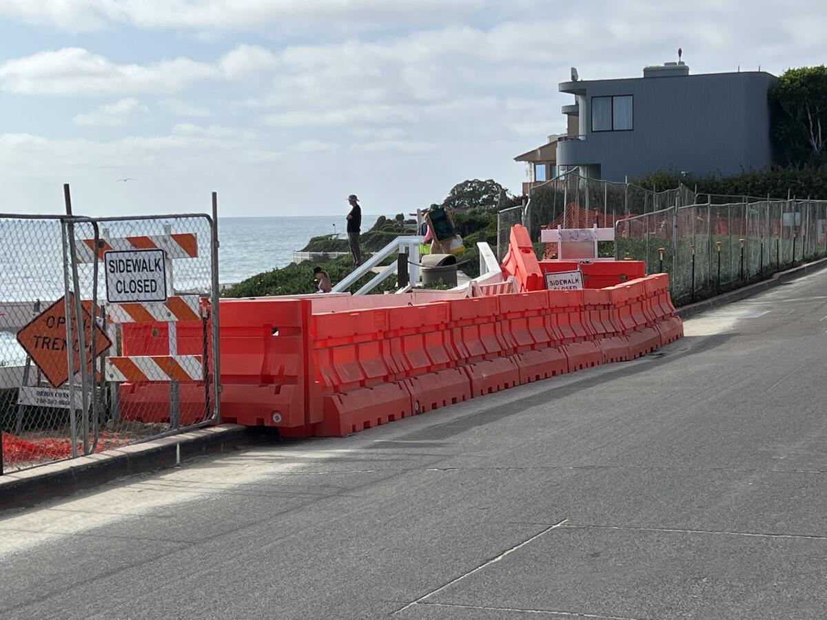 Barricades surrounding a site awaiting construction at Windansea Beach create a hazard for pedestrians, residents say.