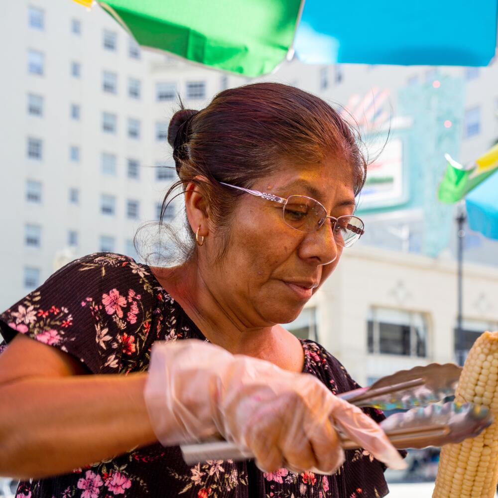 Street vendor Clara Estrada Vasquez prepares an elote