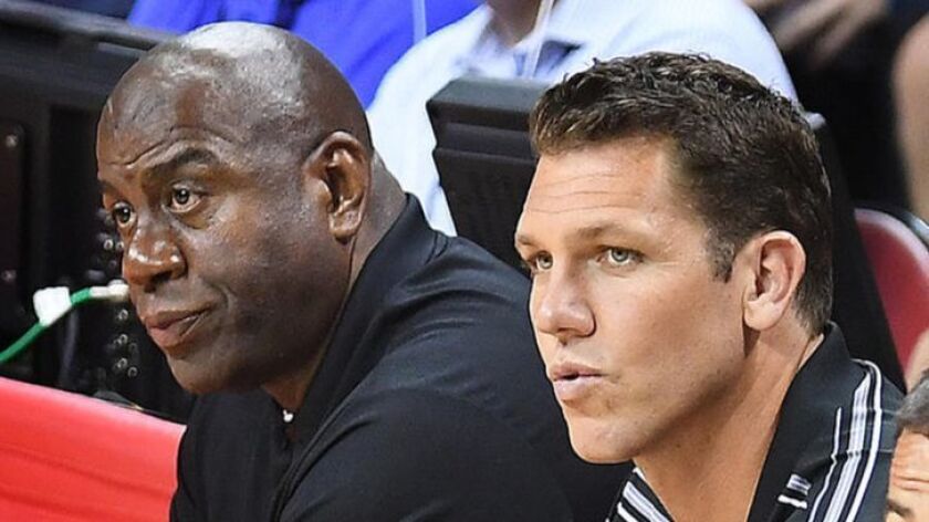 Lakers coach Luke Walton sits with Magic Johnson, the team's president of basketball operations, during an NBA Summer League game in Las Vegas.