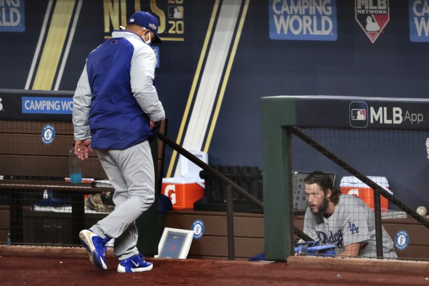 Arlington, Texas, Thursday, October 15, 2020. Clayton Kershaw sits in the dugout second.