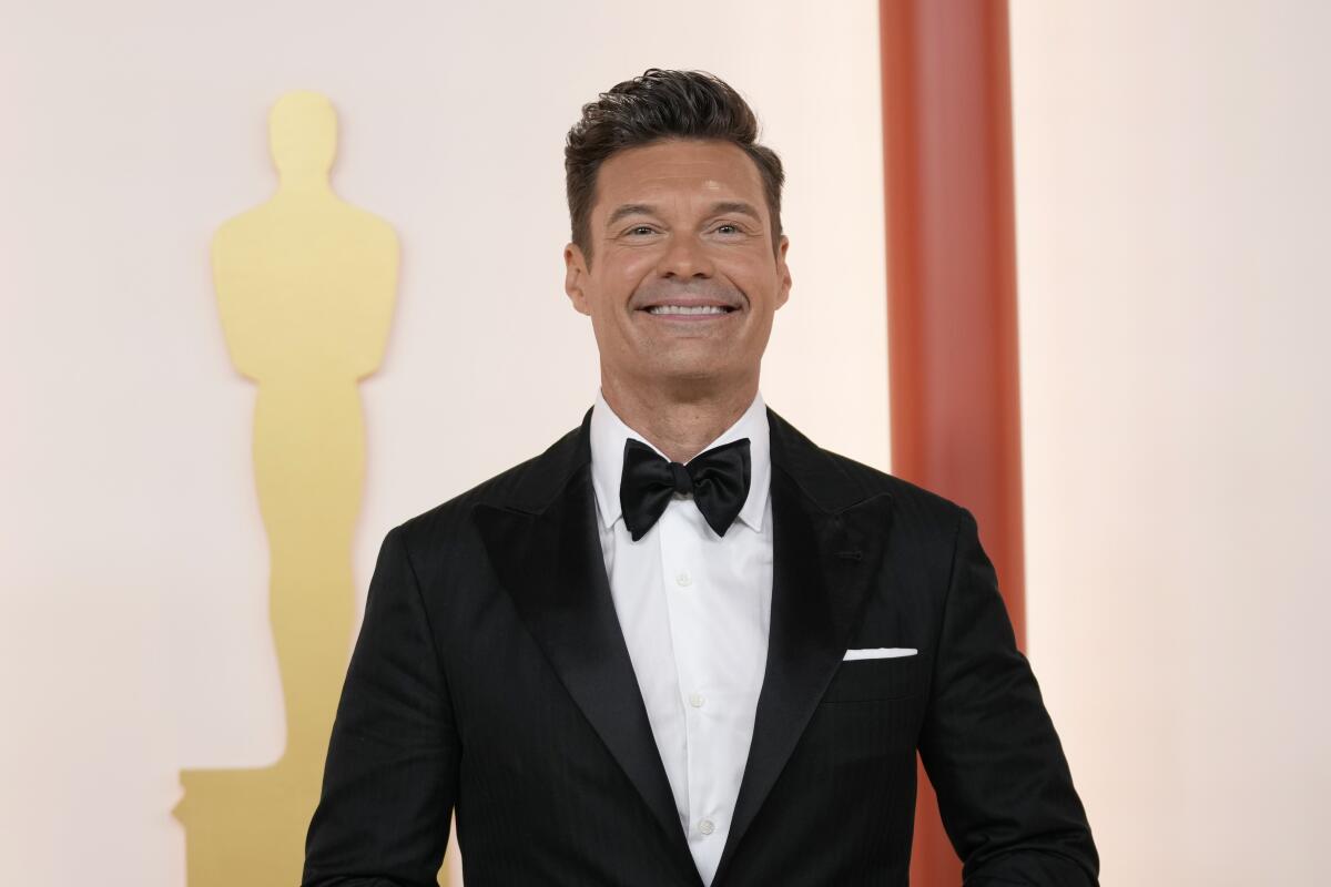 Ryan Seacrest in a tuxedo with a bow tie