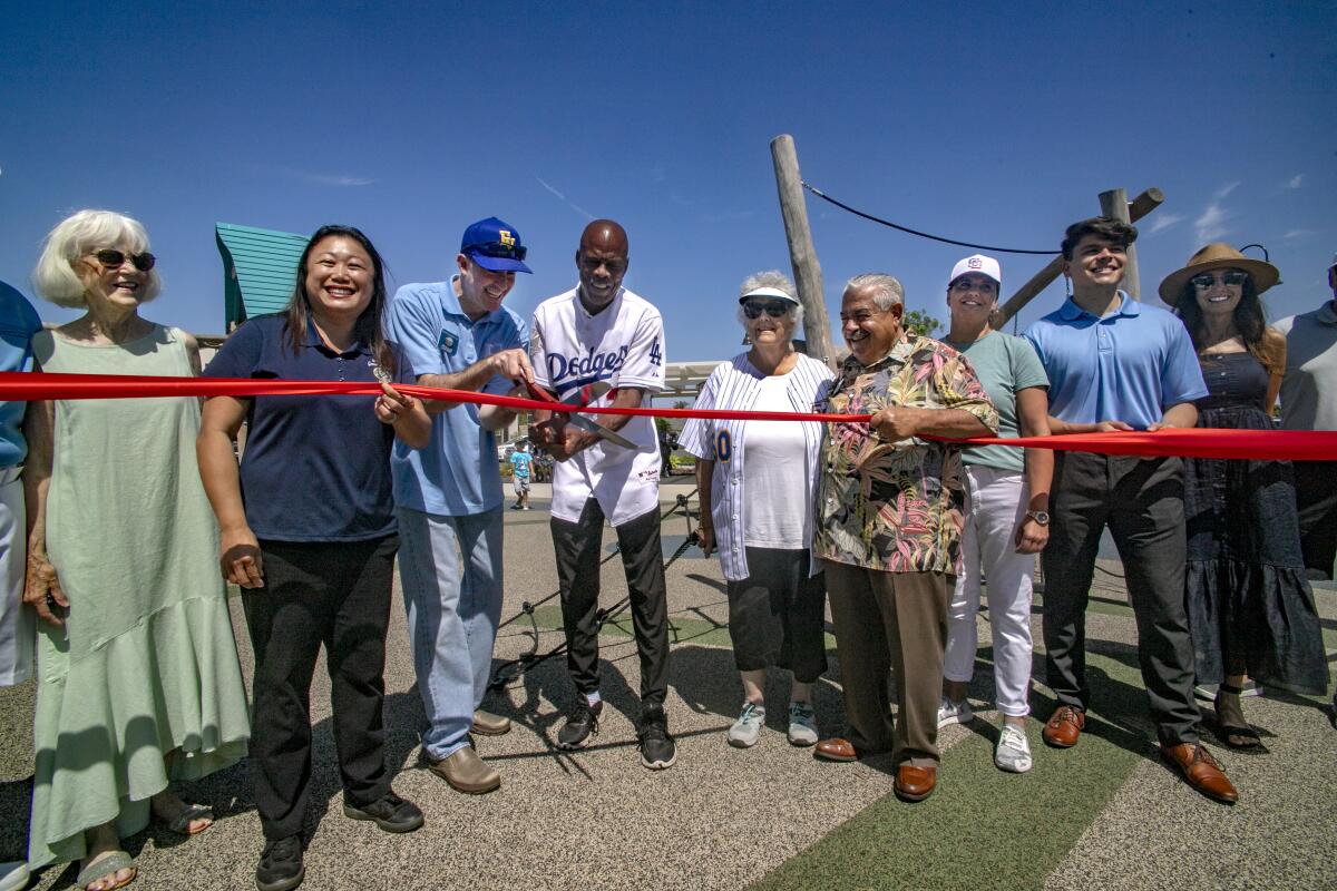 Community members and local officials participate in a ribbon-cutting ceremony for Moiola Park in Fountain Valley.