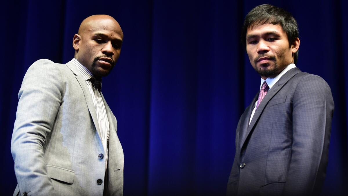 Floyd Mayweather Jr., left, and Manny Pacquiao appear at a news conference in Los Angeles on March 11 to promote their championship fight in Las Vegas on May 2.