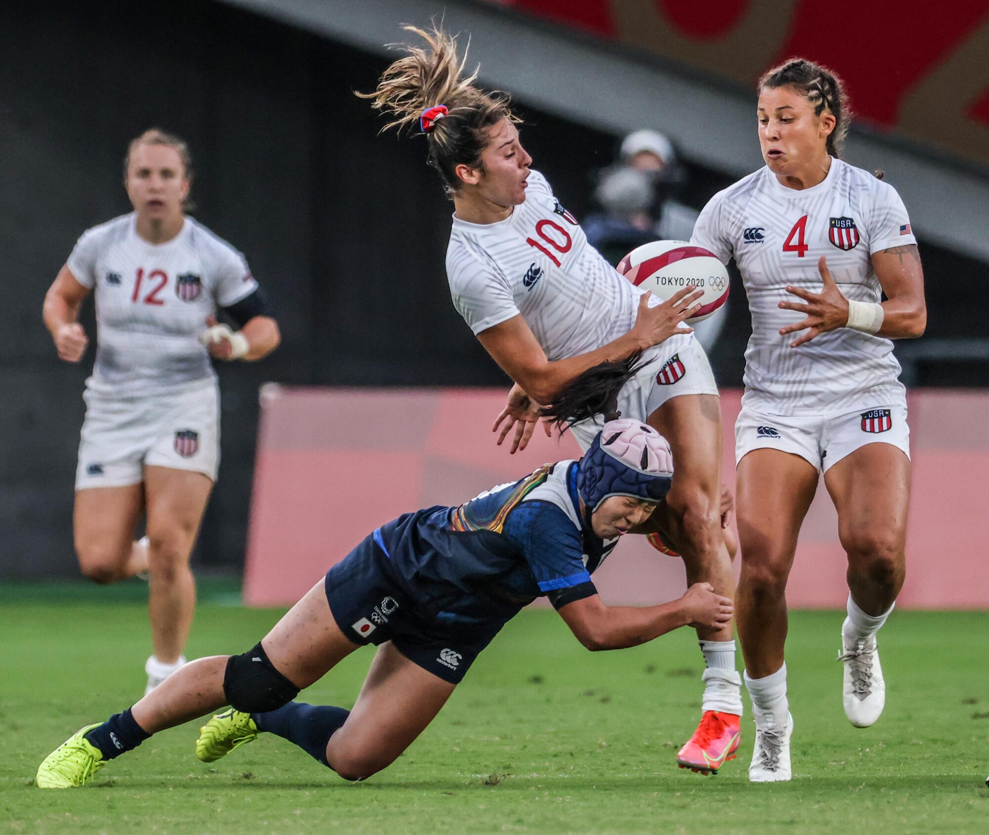 Team Japan back Mei Otani (9) cuts the legs out from under Team USA back Kayla Canett (10)