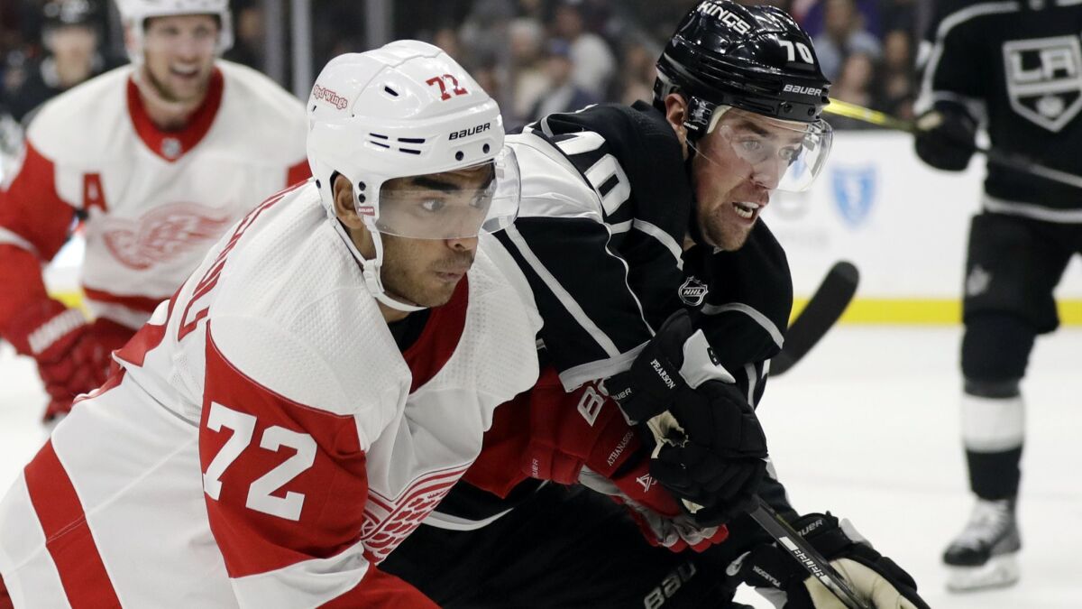 The Detroit Red Wings' Andreas Athanasiou (72) is defended by the Kings' Tanner Pearson in an Oct. 7 game at Staples Center.