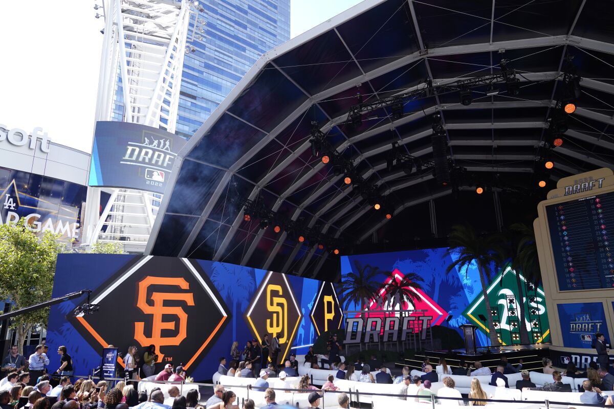 Logos from various teams are displayed during the 2022 MLB baseball draft, Sunday, July 17, 2022, in Los Angeles. (AP Photo/Jae C. Hong )