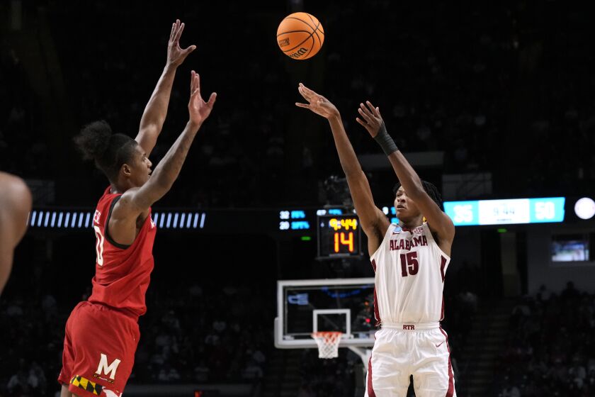 Alabama forward Noah Clowney (15) shoots past Maryland forward Julian Reese during the second half of a second-round college basketball game in the men's NCAA Tournament in Birmingham, Ala., Saturday, March 18, 2023. Alabama won 73-51. (AP Photo/Rogelio V. Solis)