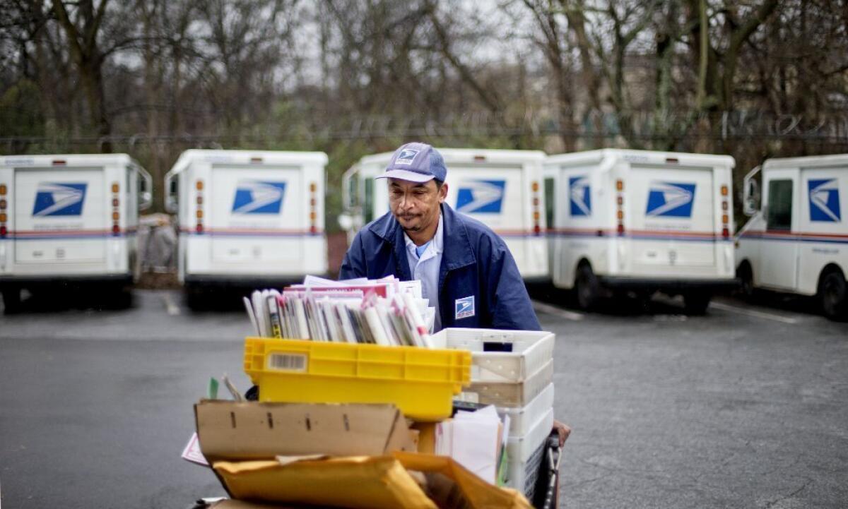 What my stuffed mailbox looks like. In reality, none of this was headed to Los Angeles. U.S. Postal Service letter carrier Michael McDonald prepares for his delivery run in Atlanta.