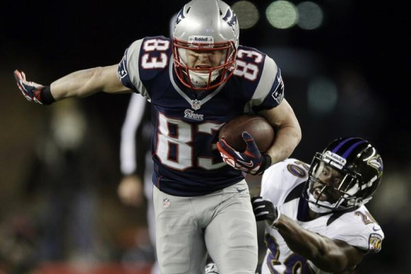 Wes Welker runs out of the tackle of Baltimore Ravens free safety Ed Reed during the AFC championship game in Foxborough, Mass.