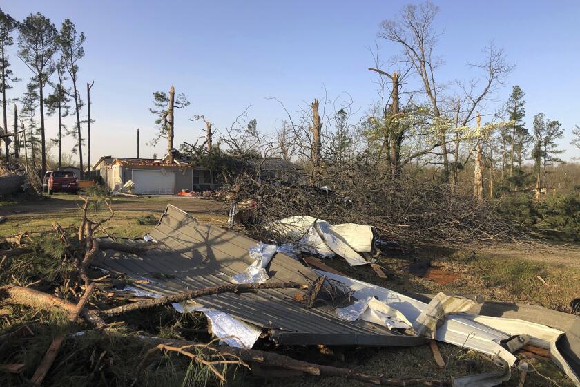 Debris covers the ground around a home that was damaged from severe weather in Wynne, Ark., on Saturday, April 1, 2023. Unrelenting tornadoes that tore through parts of the South and Midwest that shredded homes and shopping centers. (AP Photo/Adrian Sainz)