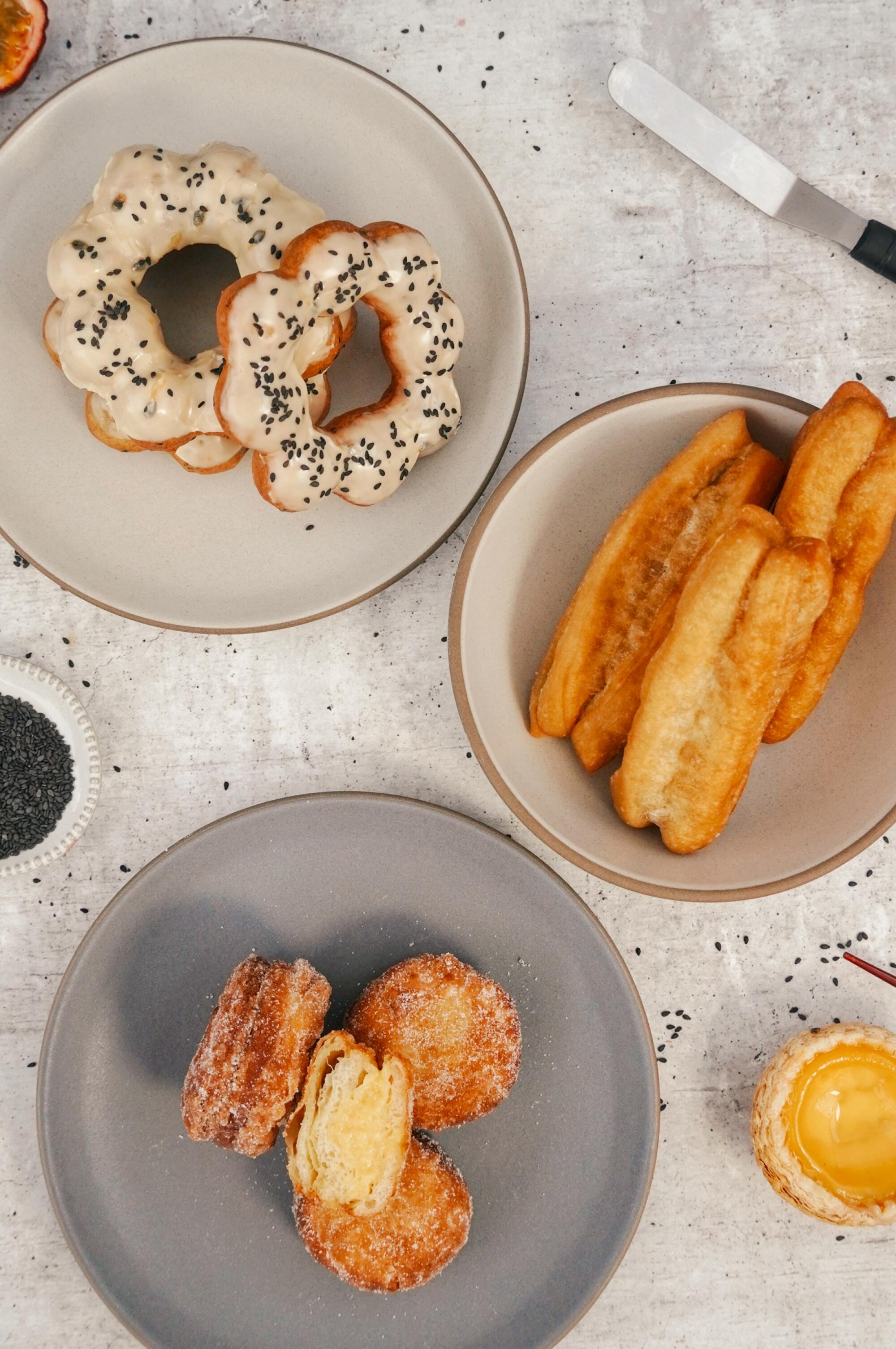 Overhead view of three different plates of pastries