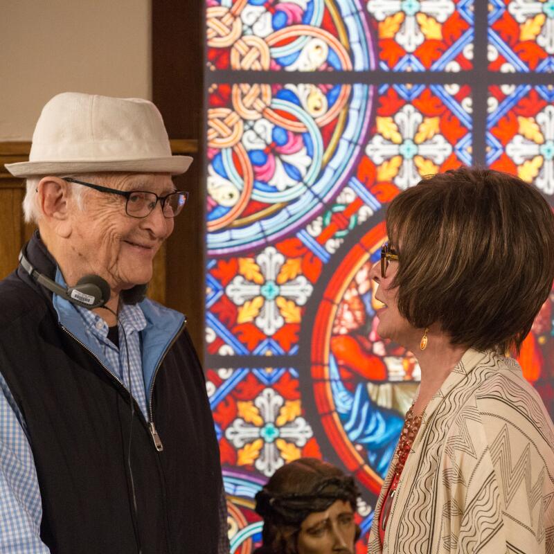 Norman Lear smiles at Rita Moreno.