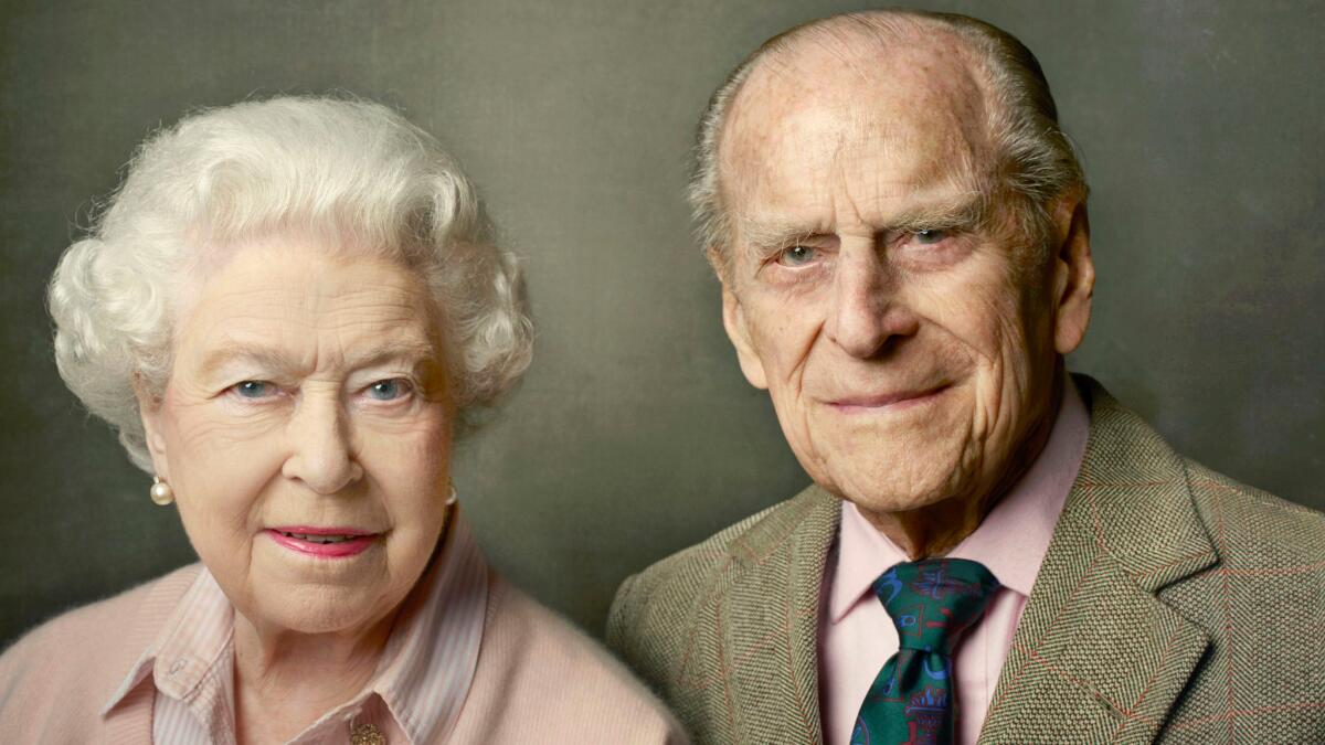 Queen Elizabeth II and Prince Philip were photographed by Annie Leibovitz in Windsor, England, for a portrait marking the queen's 90th birthday that was released Friday by Buckingham Palace.