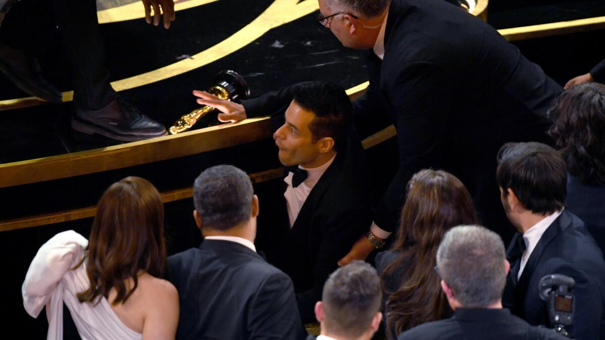 Rami Malek slips shortly after winning the lead actor Oscar at the 91st Academy Awards at the Dolby Theatre in Hollywood.