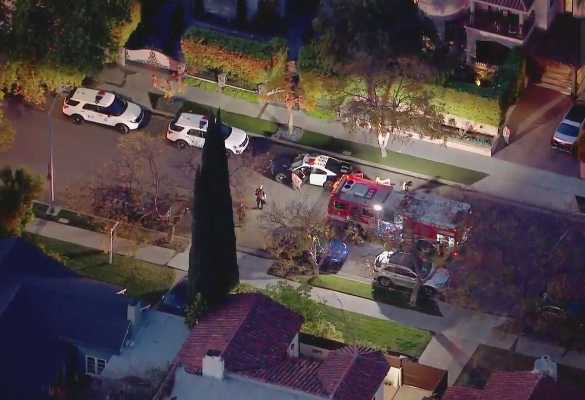 An aerial view of a police cars in a neighborhood. 