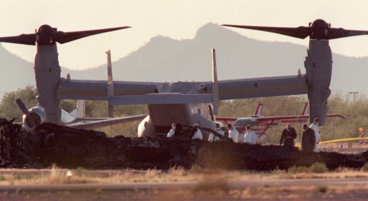 In April 2000, investigators work near an MV-22 Osprey at Avra Valley Airport in Marana, Ariz.