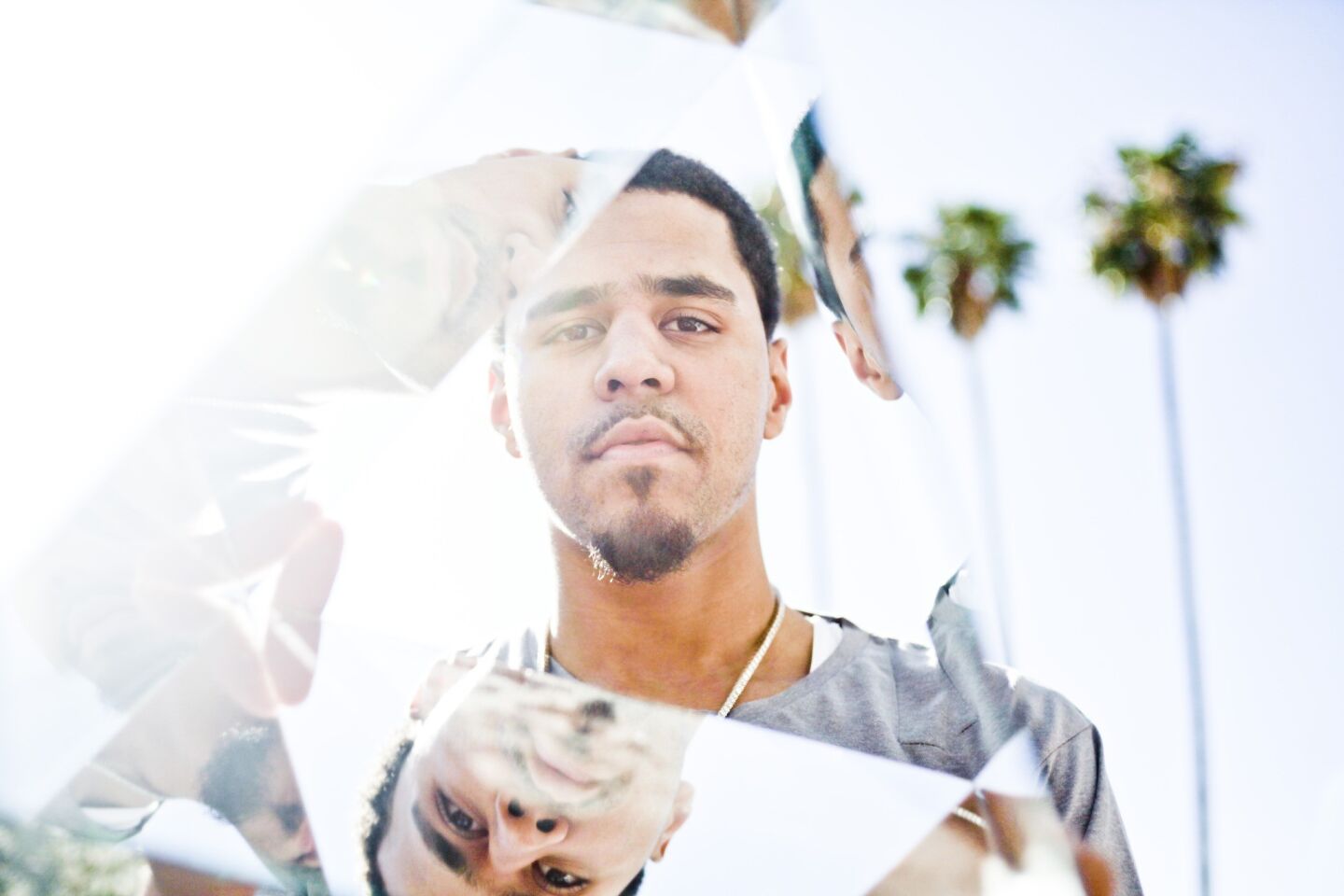 J. Cole, seen here looking through a prism of mirrors, has released his second album, "Born Sinner."