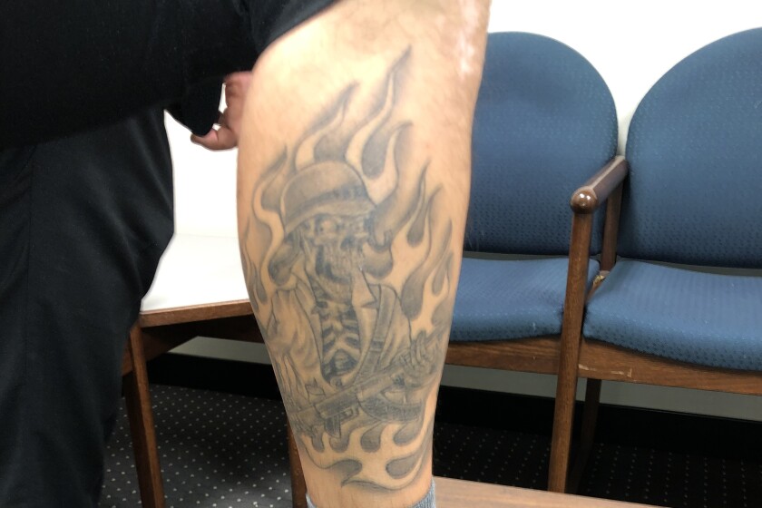 A Compton deputy's tattoo photographed as part of an excessive force lawsuit.