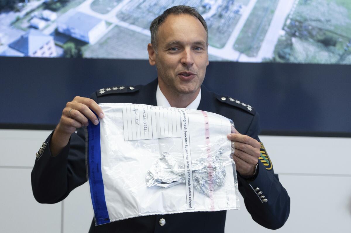 Police spokesman Thomas Geithner shows the remains of the metal foil of a balloon during a press conference in Dresden, Germany, Tuesday, Sept 14, 2021 discovered in the substation Dresden-Sued (Dresden-South). German police are investigating the source of a balloon that caused a massive blackout Monday in and around the eastern German city of Dresden. (Sebastian Kahnert/dpa via AP)